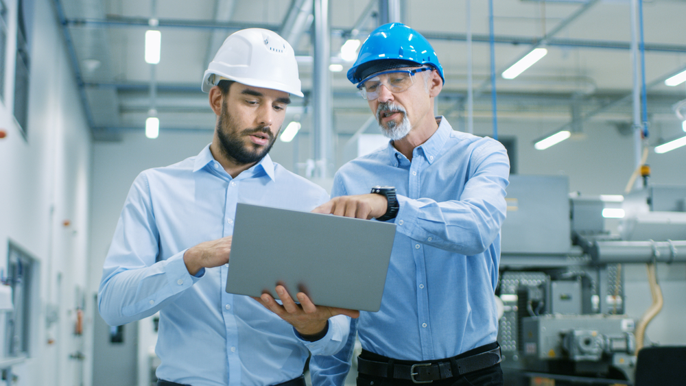 Head,Of,The,Project,Holds,Laptop,And,Discusses,Product,Details